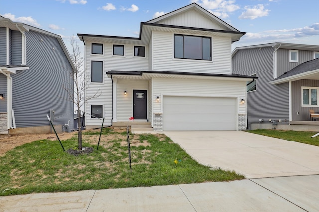 view of front facade with concrete driveway, an attached garage, and a front yard