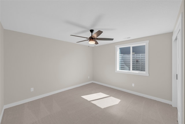 carpeted empty room with ceiling fan