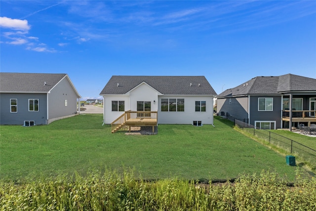 back of house featuring a yard and a wooden deck