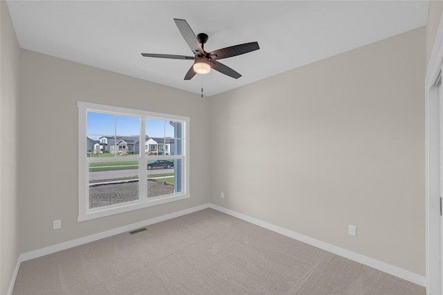 unfurnished room with carpet flooring and ceiling fan