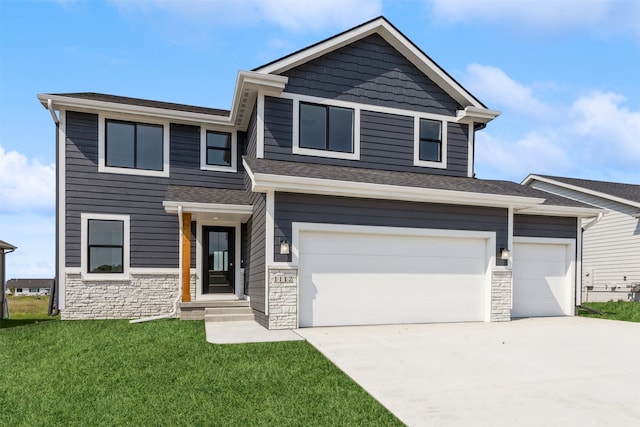 view of front of property featuring a garage and a front lawn