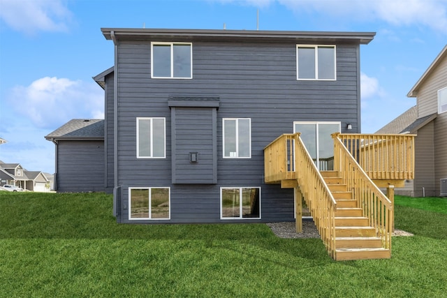 rear view of property with a yard and central AC