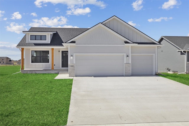 view of front of house with a garage and a front lawn