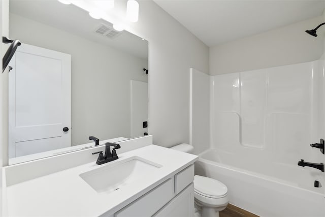 full bathroom featuring shower / washtub combination, wood-type flooring, vanity, and toilet