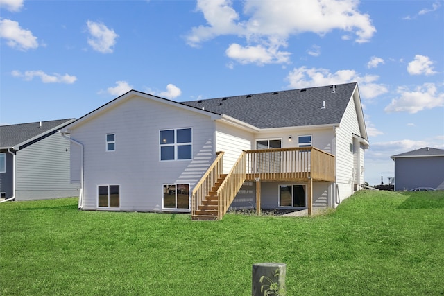 back of property featuring a wooden deck and a yard