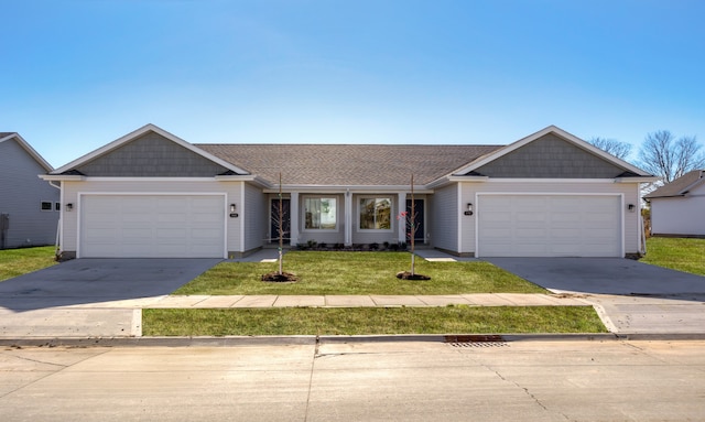 ranch-style house with a garage and a front lawn