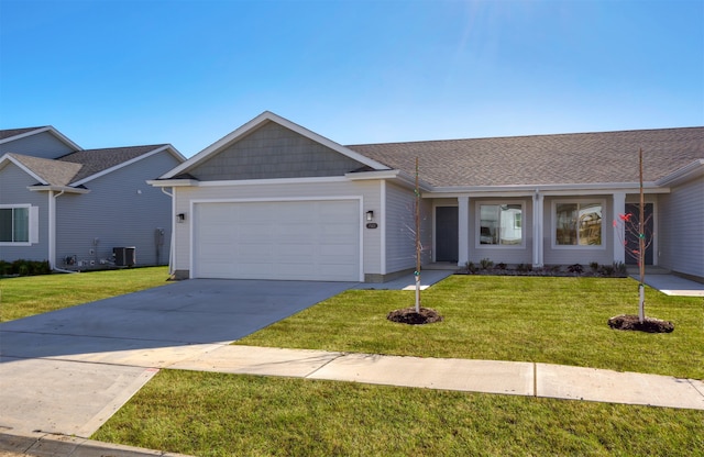 ranch-style house with a garage and a front lawn