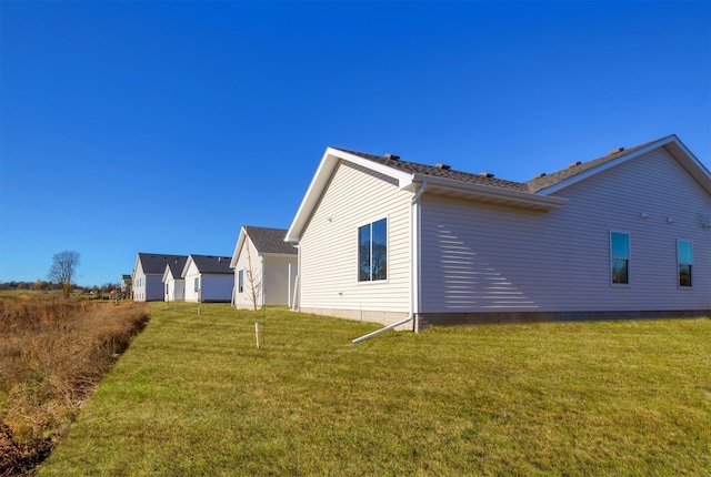 rear view of house with a yard