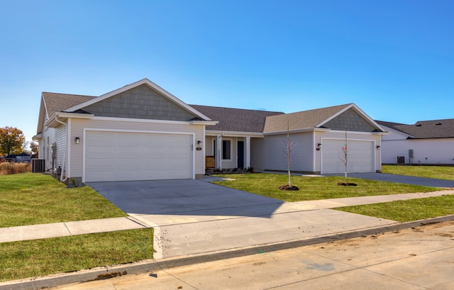 ranch-style home with central AC unit, a garage, and a front yard