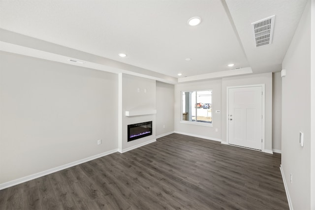 unfurnished living room featuring dark wood-type flooring