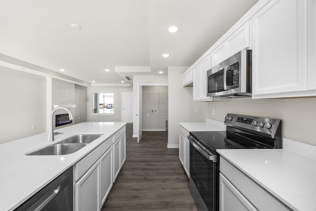 kitchen with white cabinetry, stainless steel appliances, sink, and dark hardwood / wood-style flooring