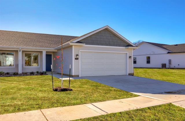 ranch-style home featuring a front yard, a garage, and cooling unit