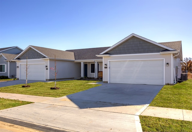 ranch-style home featuring a garage, central AC unit, and a front yard