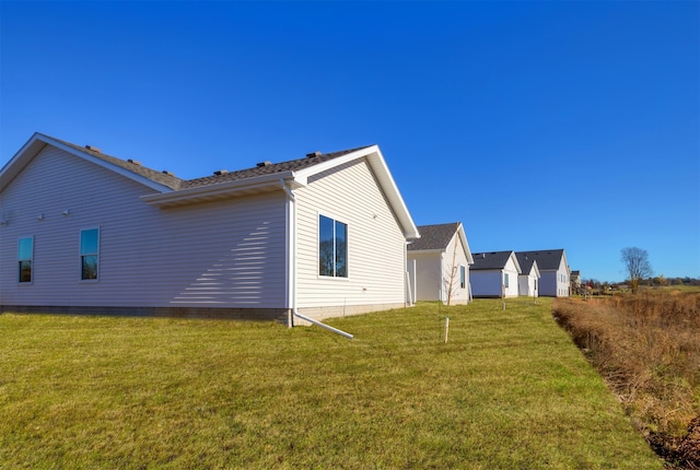 view of side of property with a yard