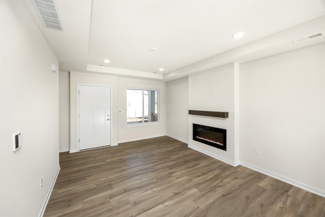 unfurnished living room featuring hardwood / wood-style floors