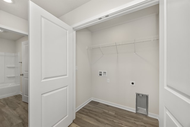 clothes washing area featuring dark wood-type flooring, washer hookup, and hookup for an electric dryer