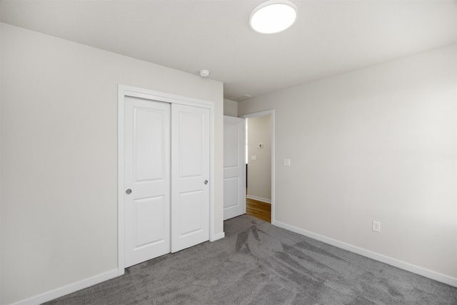 unfurnished bedroom featuring carpet and a closet