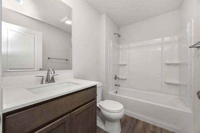 full bathroom featuring hardwood / wood-style flooring, vanity, toilet, and bathtub / shower combination