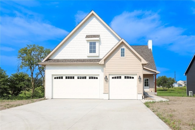 1773 Highland Cir SW, Altoona, IA 50009 - view of front facade with concrete driveway, an attached garage, and a chimney