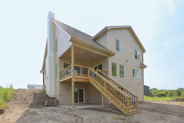 1773 Highland Cir SW, Altoona, IA 50009 - rear view of property with stairway, a chimney, a patio, a wooden deck, and roof with shingles