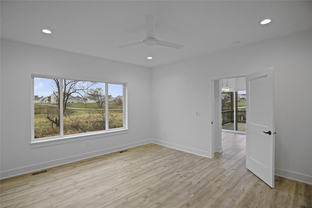 1773 Highland Cir SW, Altoona, IA 50009 - unfurnished room featuring healthy amount of natural light, recessed lighting, a ceiling fan, light wood finished floors, and a chandelier