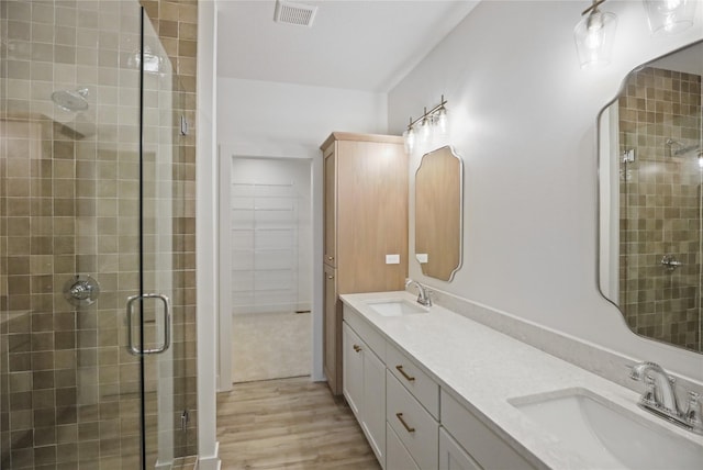 1773 Highland Cir SW, Altoona, IA 50009 - bathroom with a shower stall, wood finished floors, and double vanity
