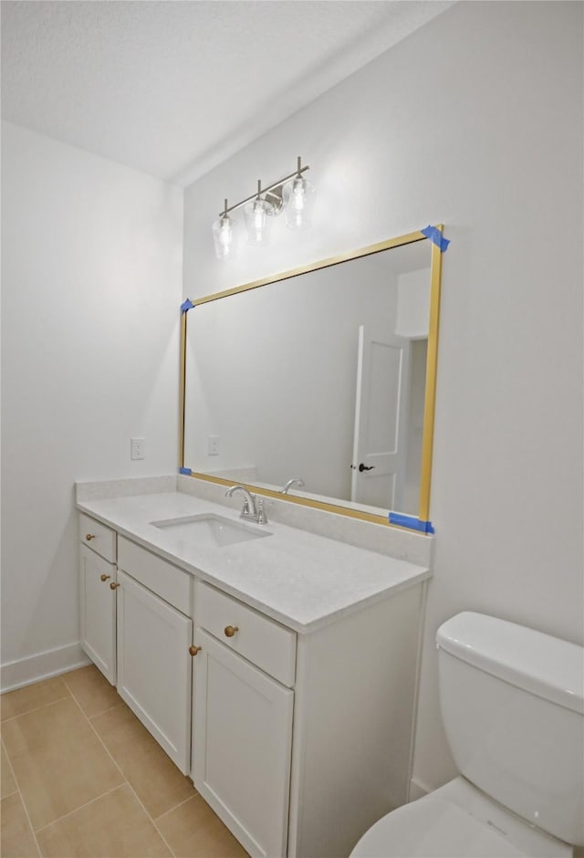 1773 Highland Cir SW, Altoona, IA 50009 - bathroom with tile patterned flooring, toilet, vanity, and baseboards