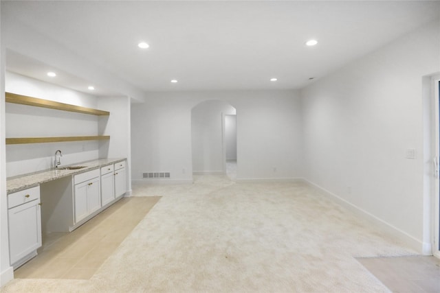 1773 Highland Cir SW, Altoona, IA 50009 - below grade area with recessed lighting, arched walkways, wet bar, light colored carpet, and baseboards
