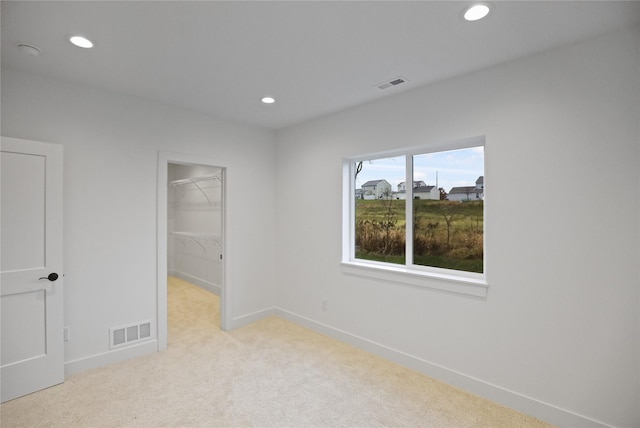 1773 Highland Cir SW, Altoona, IA 50009 - unfurnished bedroom with carpet flooring, recessed lighting, a spacious closet, baseboards, and a closet