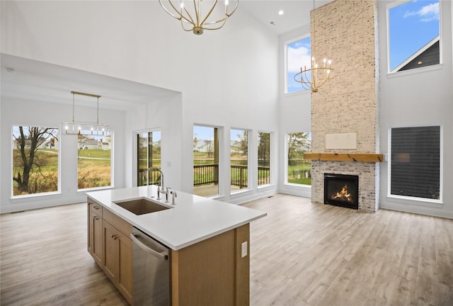 1773 Highland Cir SW, Altoona, IA 50009 - kitchen featuring a chandelier, dishwasher, a sink, a high ceiling, and pendant lighting