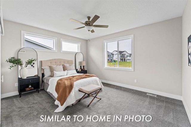 bedroom with ceiling fan and dark carpet