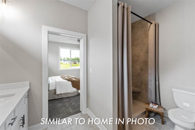 bathroom featuring tile patterned flooring, vanity, toilet, and walk in shower