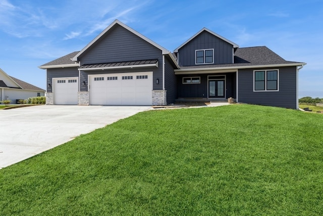 view of front of house featuring a front lawn and a garage