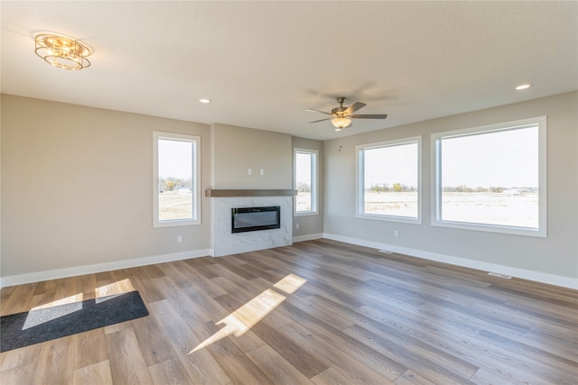 unfurnished living room featuring light hardwood / wood-style floors and ceiling fan