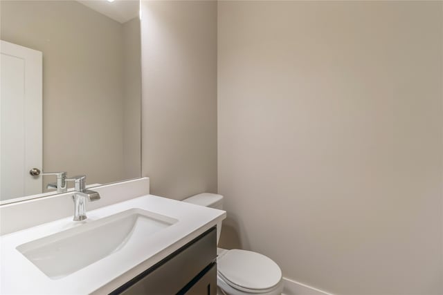 bathroom with toilet and vanity