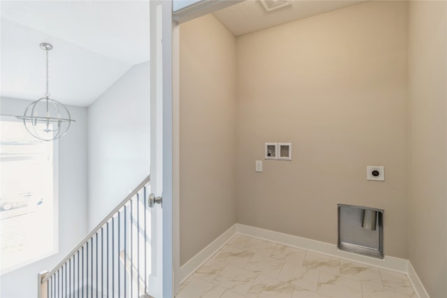 laundry area with hookup for an electric dryer, a chandelier, and washer hookup