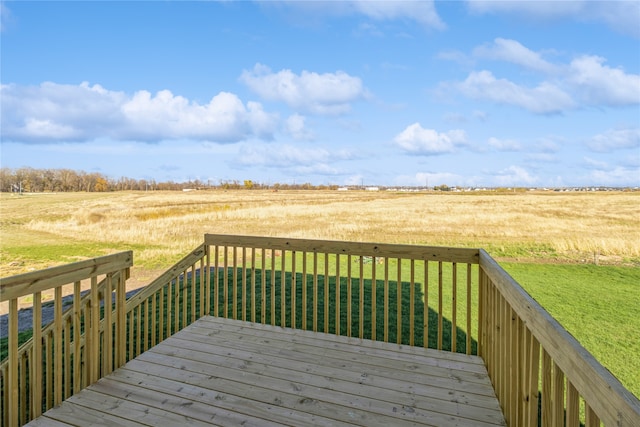 deck with a rural view and a lawn