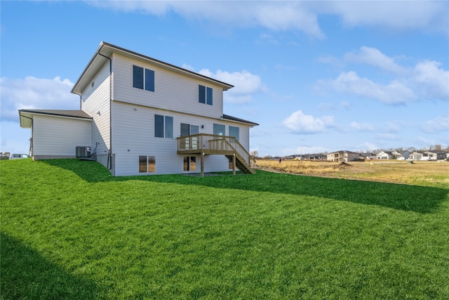 back of property with a yard, a deck, and central AC unit