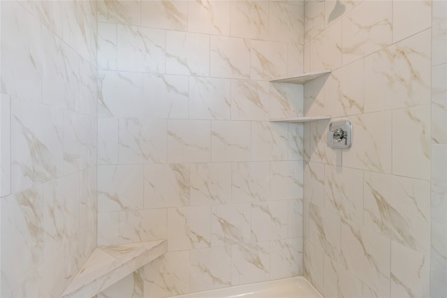 bathroom with tiled shower