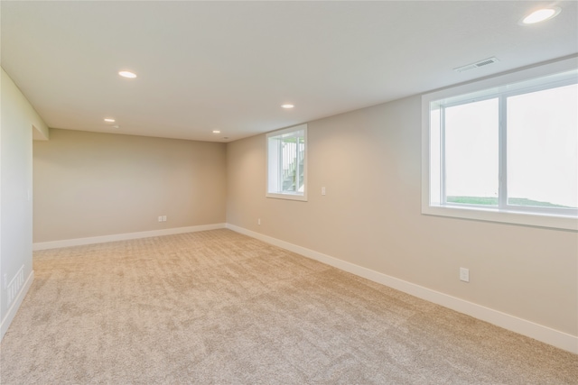 empty room with light carpet and a healthy amount of sunlight