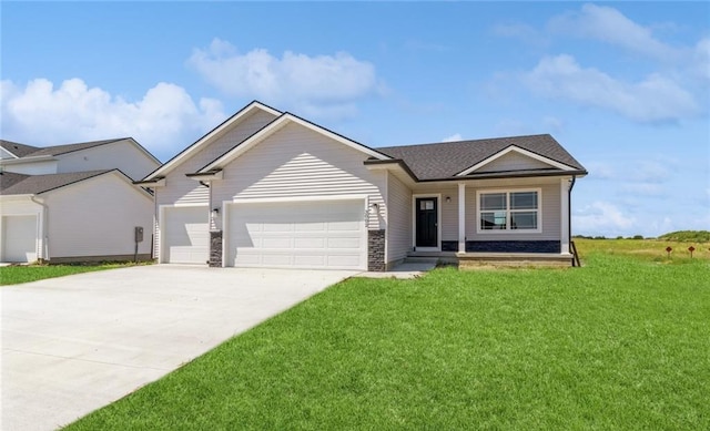 view of front of home with a garage and a front lawn