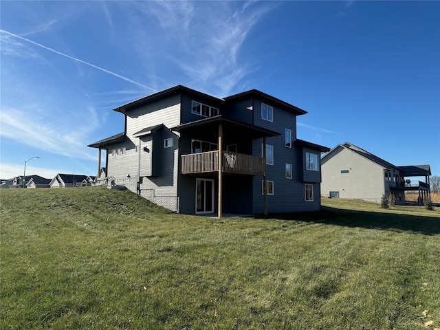 rear view of property featuring a lawn