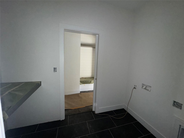 laundry area featuring dark tile patterned floors