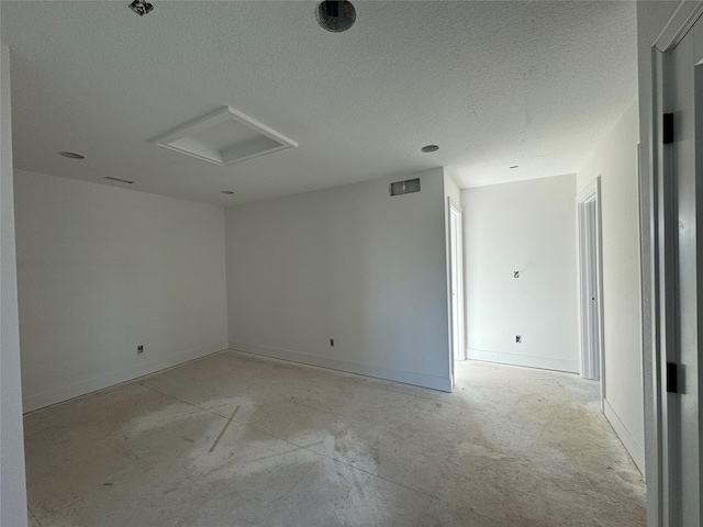 unfurnished room featuring a textured ceiling