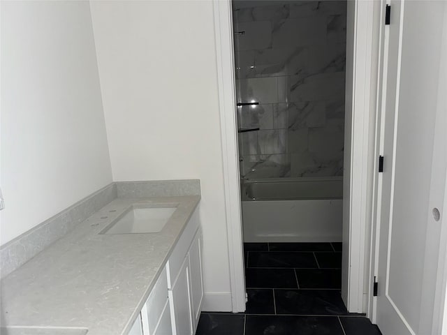 bathroom featuring tile patterned flooring, vanity, and tiled shower / bath combo