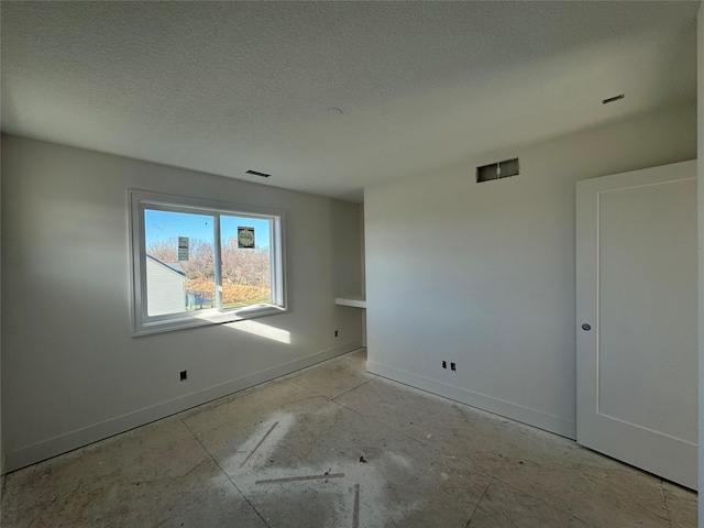 empty room featuring a textured ceiling