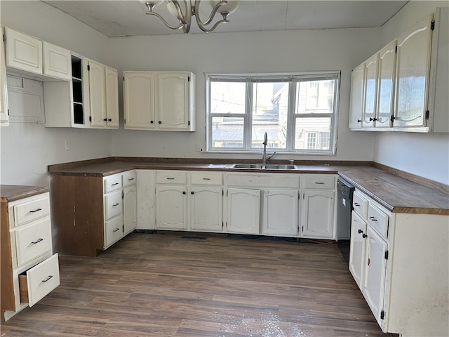 kitchen with white cabinetry, an inviting chandelier, dark hardwood / wood-style flooring, sink, and dishwasher