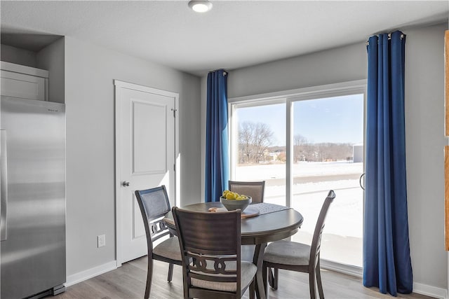 dining area featuring wood finished floors and baseboards