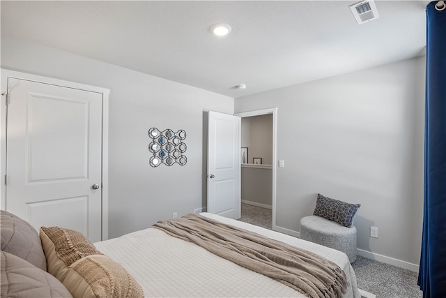 carpeted bedroom with visible vents and baseboards