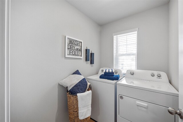 clothes washing area featuring laundry area and washing machine and clothes dryer